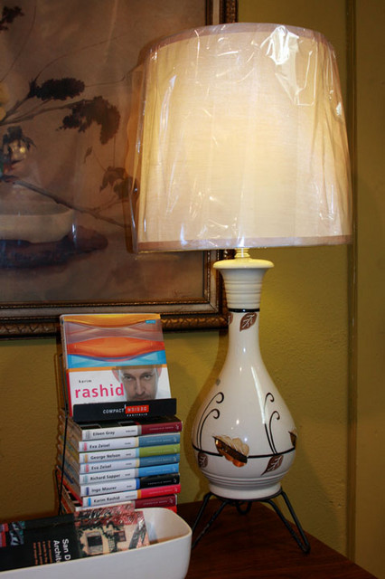 Vintage mid century modern white ceramic lamp with hand-painted black and gold leaf in the style of Heidi Schoup with hair pin stylized metal base and new drum lamp shade.  31 inches to the top of the finial, base is 6.5 inches wide at its widest point.  $495 

SKU# L0011